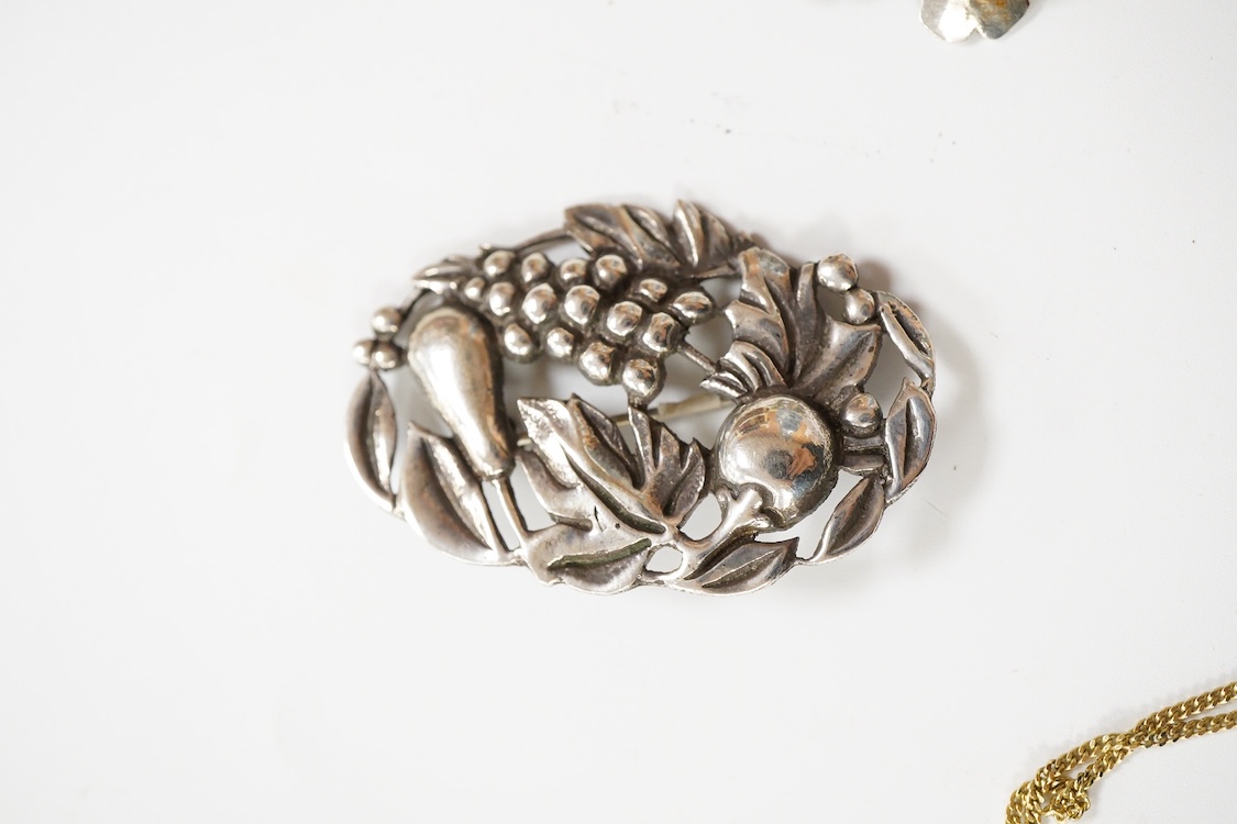 An 800 standard gilt white metal and garnet cluster set oval pendant, 18mm, on a 585 yellow metal fine link chain, 2.5 grams, a gilt white metal and garnet cluster set hinged bangle, two white metal brooches including on